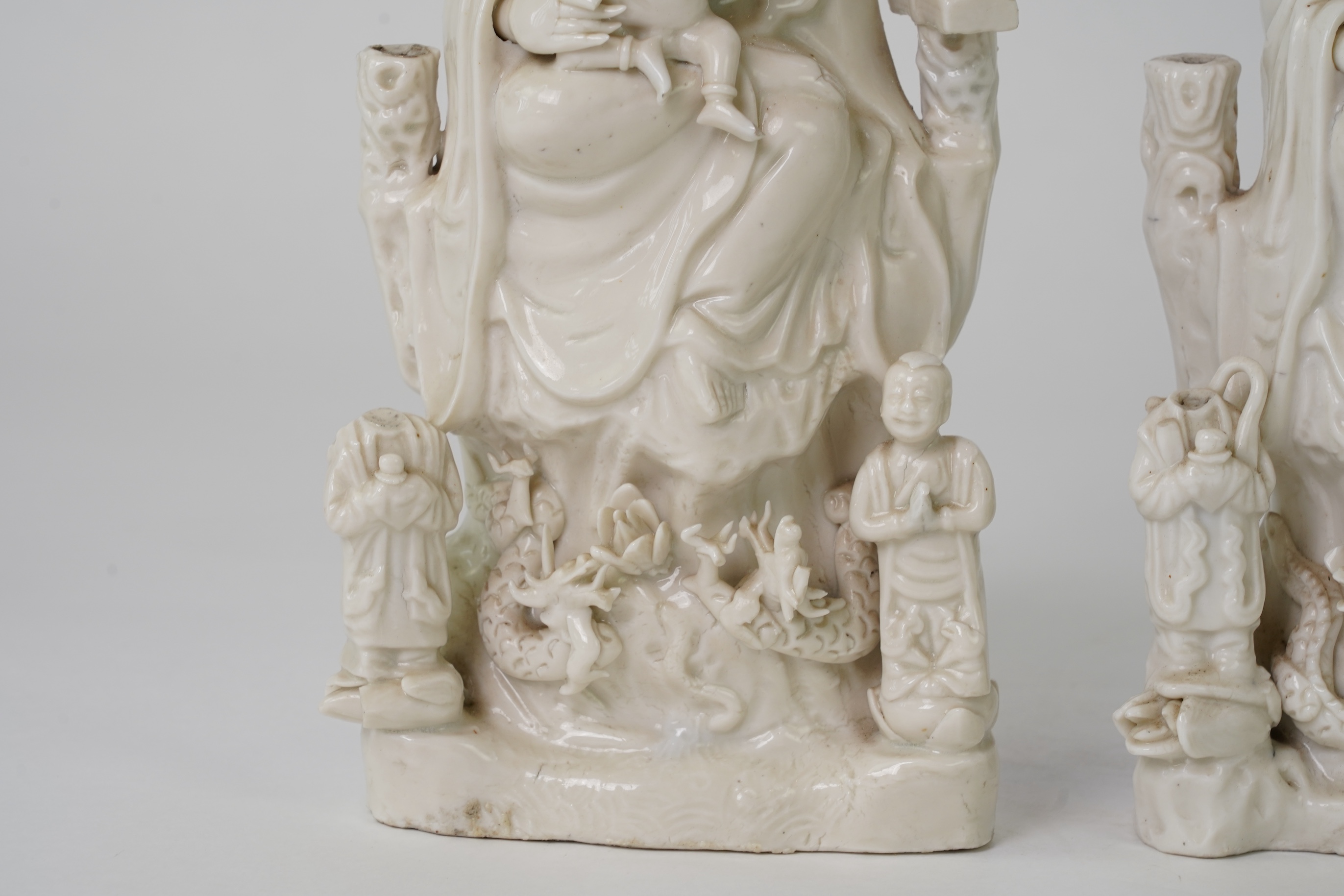 A pair of Chinese blanc de chine groups of Guanyin and children, 18th century